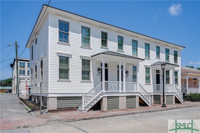 view of front of home with a porch, metal roof, and a standing seam roof