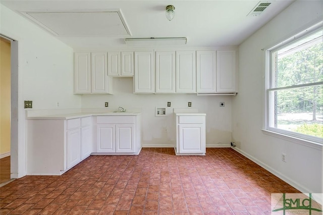 clothes washing area featuring visible vents, hookup for an electric dryer, attic access, cabinet space, and hookup for a washing machine