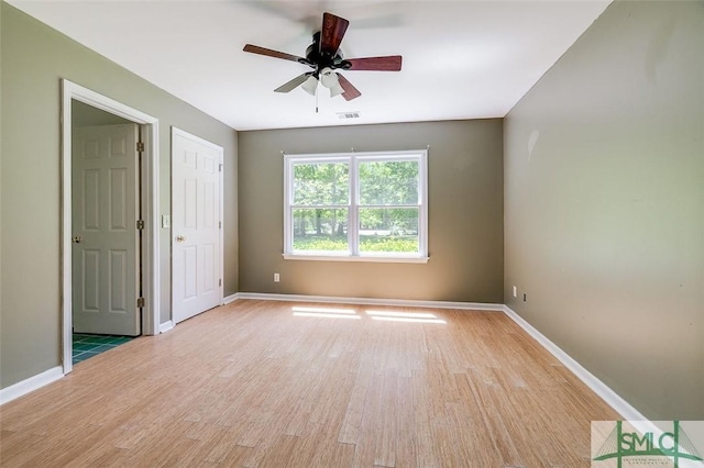 unfurnished bedroom featuring light wood-style flooring, baseboards, and visible vents