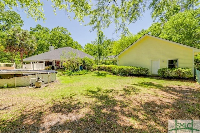 view of yard with a covered pool