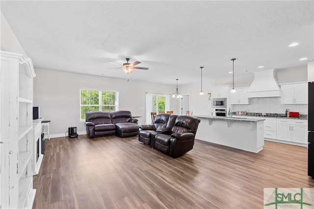314 Providence Trce, Statesboro, GA 30461 - living room featuring wood finished floors, a fireplace, a ceiling fan, and recessed lighting
