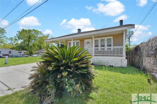 bungalow with a front yard and a porch