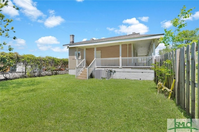 view of front of house with a porch, fence, and a front lawn