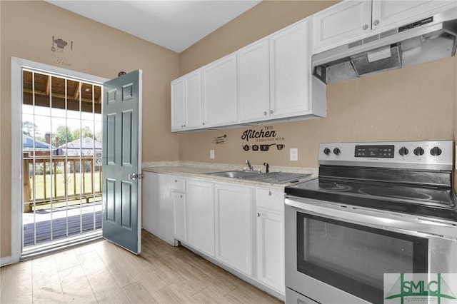 633 W 39th St, Savannah, GA 31415 - kitchen featuring stainless steel range with electric cooktop, white cabinetry, under cabinet range hood, a sink, and light countertops