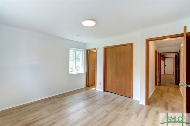 12445 Deerfield Rd, Savannah, GA 31419 - unfurnished bedroom featuring baseboards, light wood-style flooring, a closet, and attic access