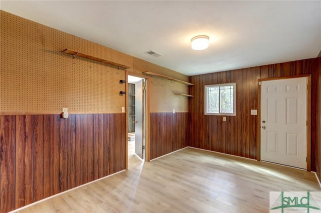 12445 Deerfield Rd, Savannah, GA 31419 - spare room with wooden walls, visible vents, and wood finished floors