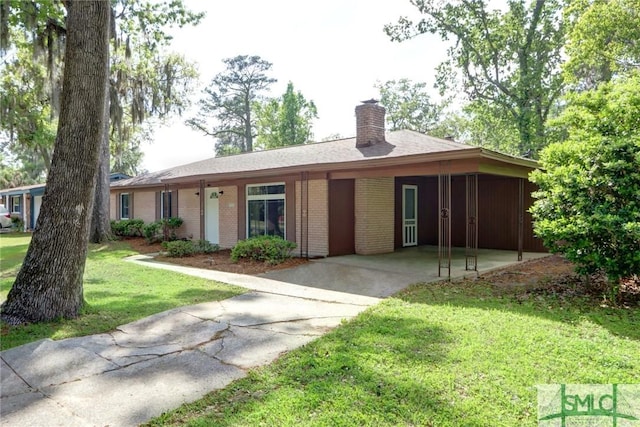 12445 Deerfield Rd, Savannah, GA 31419 - ranch-style home with a front yard, brick siding, a chimney, driveway, and an attached carport