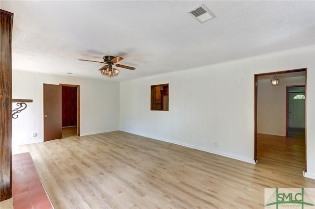 12445 Deerfield Rd, Savannah, GA 31419 - unfurnished room featuring baseboards, light wood-type flooring, a textured ceiling, a ceiling fan, and visible vents