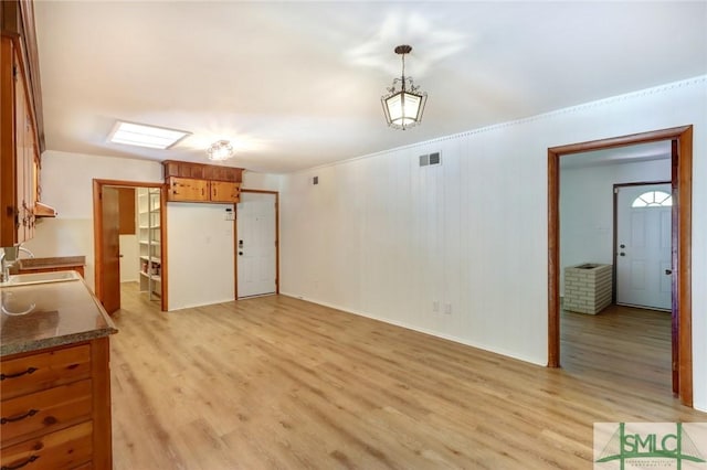 12445 Deerfield Rd, Savannah, GA 31419 - unfurnished dining area with baseboards, light wood finished floors, a sink, and visible vents
