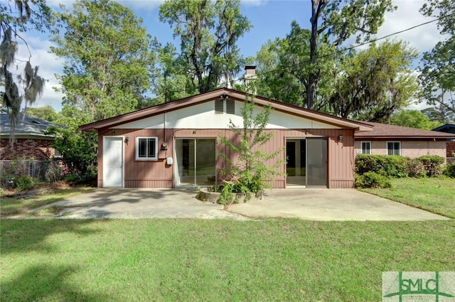 12445 Deerfield Rd, Savannah, GA 31419 - rear view of property with a patio, a chimney, fence, and a lawn