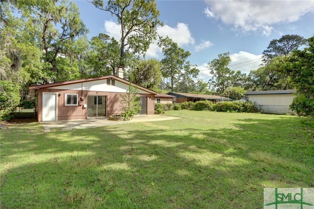 12445 Deerfield Rd, Savannah, GA 31419 - back of house with a patio, a yard, and a chimney