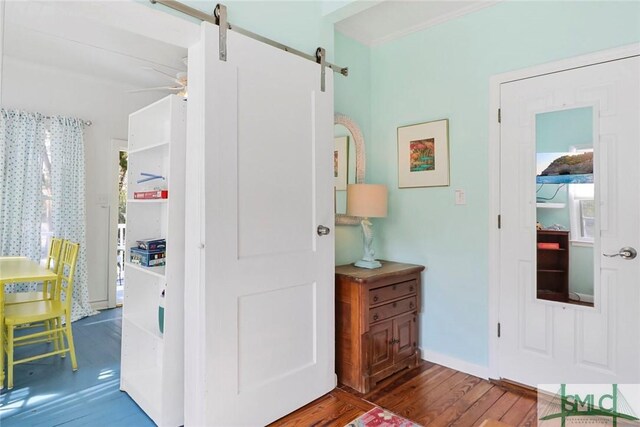 712 2nd Ave, Tybee Island, GA 31328 - corridor featuring baseboards, a barn door, and wood finished floors