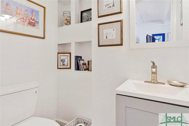712 2nd Ave, Tybee Island, GA 31328 - bathroom with vanity, toilet, and built in shelves
