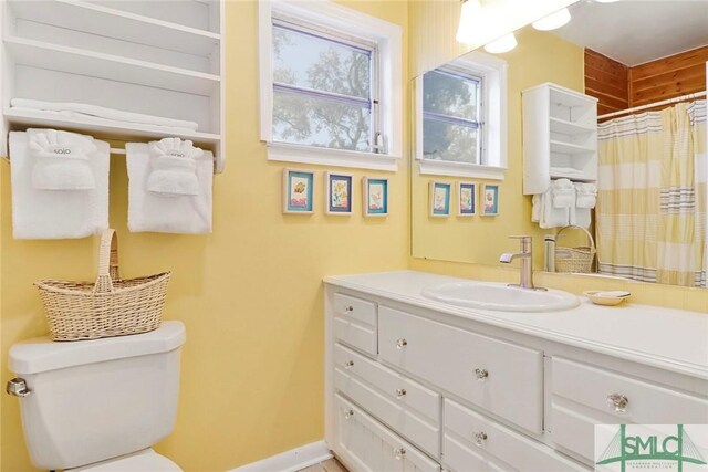 712 2nd Ave, Tybee Island, GA 31328 - full bath featuring vanity, baseboards, a shower with shower curtain, and toilet