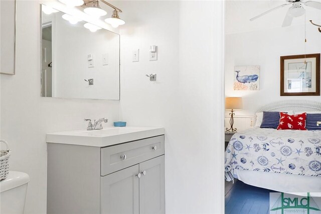 712 2nd Ave, Tybee Island, GA 31328 - bathroom featuring vanity, wood finished floors, toilet, ceiling fan, and connected bathroom