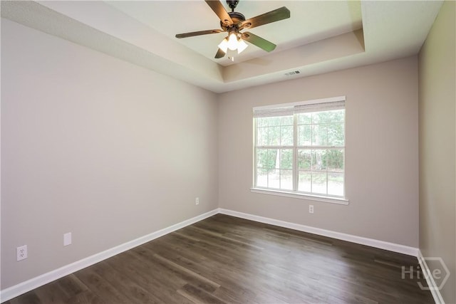 111 Tappan Zee Dr, Pooler, GA 31322 - spare room featuring a raised ceiling, baseboards, and dark wood-type flooring