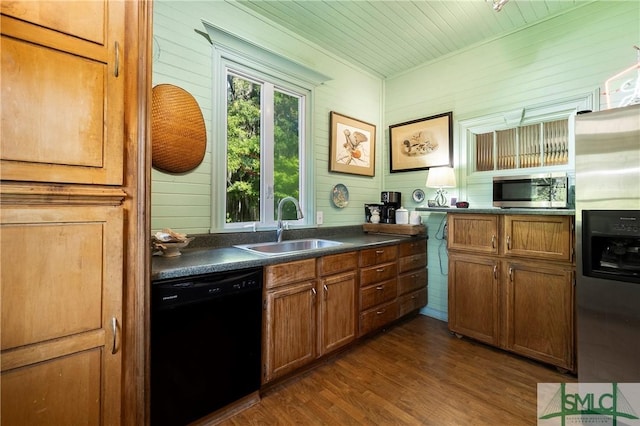 103 Church St, Bloomingdale, GA 31302 - kitchen with dark countertops, brown cabinets, a sink, and appliances with stainless steel finishes