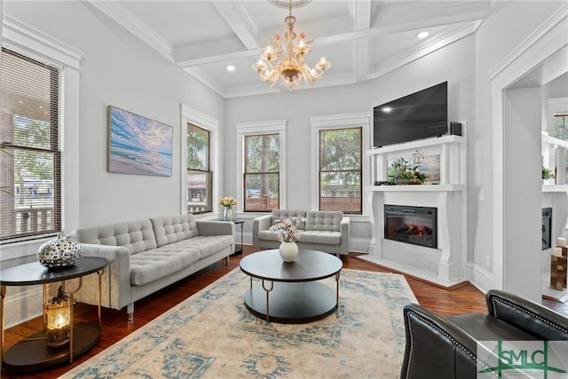 living room featuring an inviting chandelier, beam ceiling, wood finished floors, a fireplace with flush hearth, and coffered ceiling