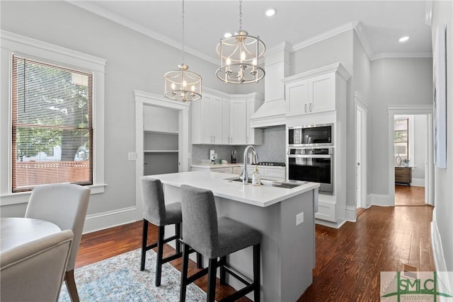 kitchen with baseboards, an inviting chandelier, light countertops, appliances with stainless steel finishes, and dark wood-style floors