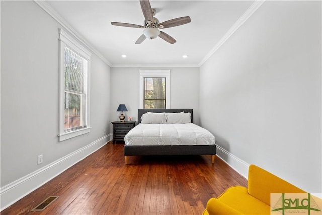 bedroom featuring visible vents, baseboards, and hardwood / wood-style floors
