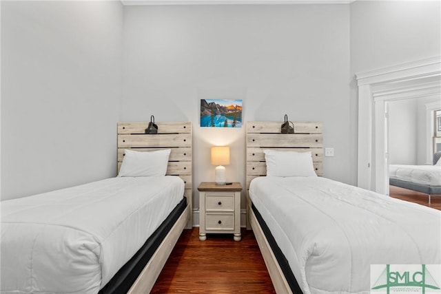 bedroom with dark wood-style flooring