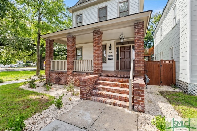 american foursquare style home featuring covered porch