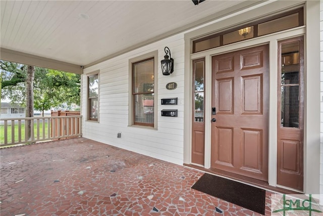 entrance to property featuring a porch