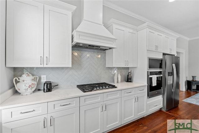 kitchen with premium range hood, white cabinets, and stainless steel appliances