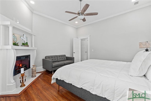 bedroom featuring wood finished floors, ornamental molding, visible vents, and recessed lighting