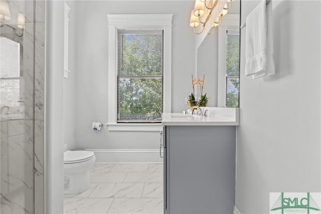 full bath featuring toilet, a chandelier, vanity, a marble finish shower, and marble finish floor