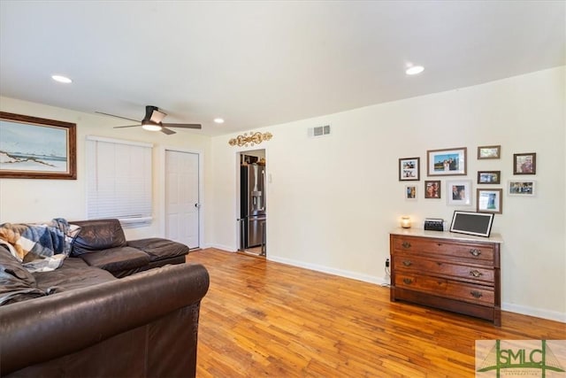 living room with visible vents, ceiling fan, light wood-type flooring, and recessed lighting