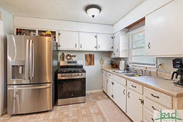 kitchen featuring a sink, light countertops, white cabinetry, and stainless steel appliances
