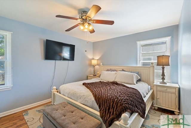 bedroom with wood finished floors, ceiling fan, and baseboards