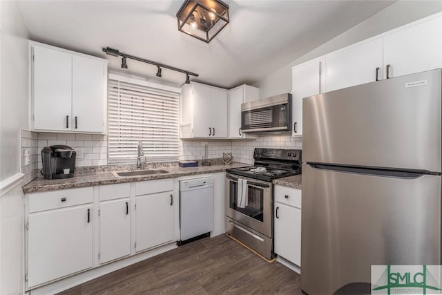 kitchen with white cabinets, dark wood-style floors, a sink, and appliances with stainless steel finishes