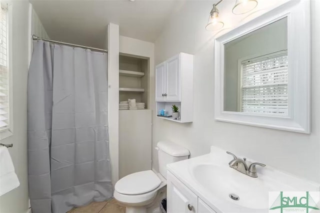 full bathroom with tile patterned flooring, toilet, vanity, and a shower with shower curtain