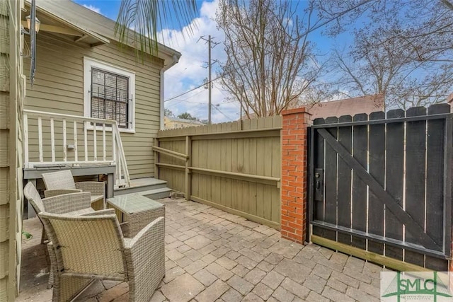 view of patio / terrace with fence and a gate