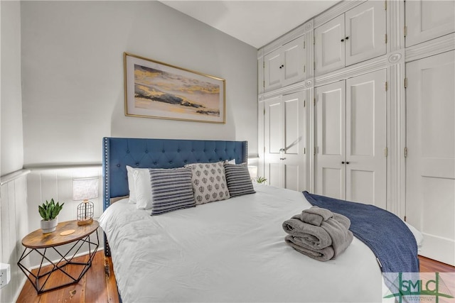 bedroom featuring wood finished floors and a closet