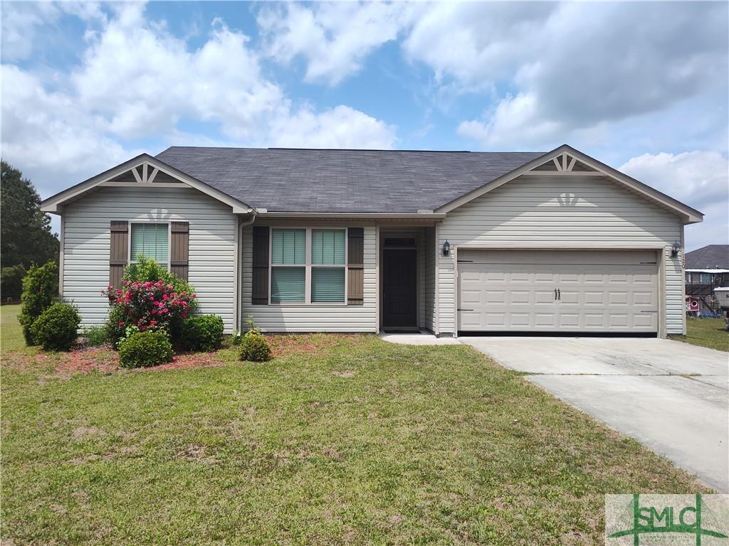 single story home with roof with shingles, driveway, a garage, and a front lawn