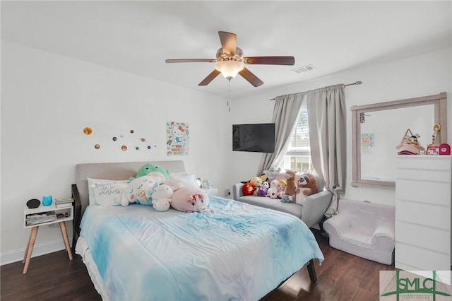 bedroom featuring visible vents, ceiling fan, baseboards, and wood finished floors