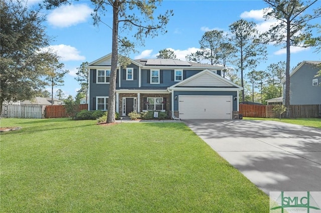 view of front of house featuring roof mounted solar panels, fence, a front yard, and concrete driveway