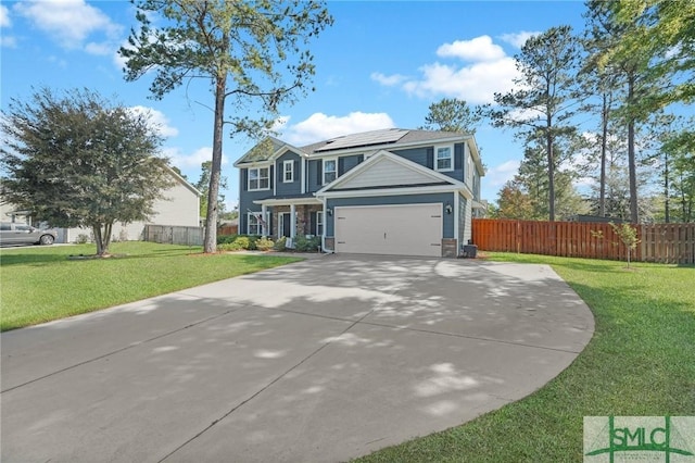 view of front of home with driveway, a front lawn, a garage, fence, and roof mounted solar panels