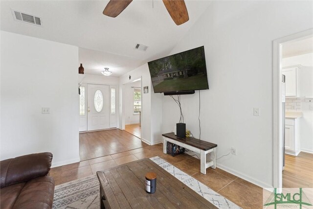 605 Weisenbaker Rd, Rincon, GA 31326 - living area with visible vents, tile patterned floors, a ceiling fan, and vaulted ceiling