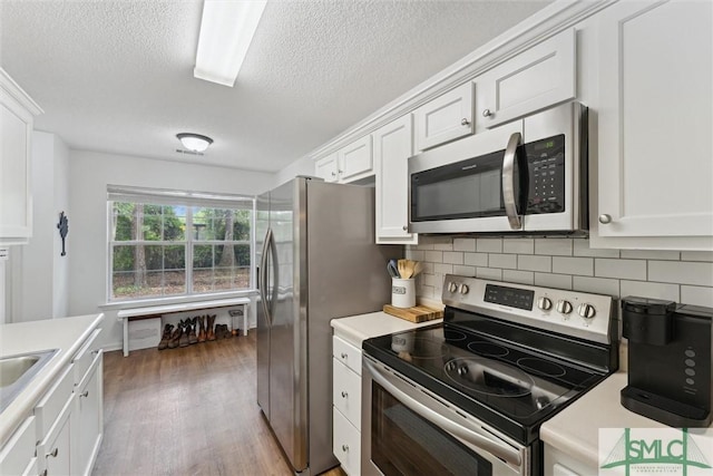 605 Weisenbaker Rd, Rincon, GA 31326 - kitchen featuring a textured ceiling, appliances with stainless steel finishes, wood finished floors, and light countertops