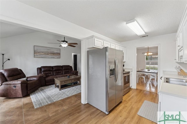 605 Weisenbaker Rd, Rincon, GA 31326 - kitchen with open floor plan, appliances with stainless steel finishes, visible vents, and white cabinets