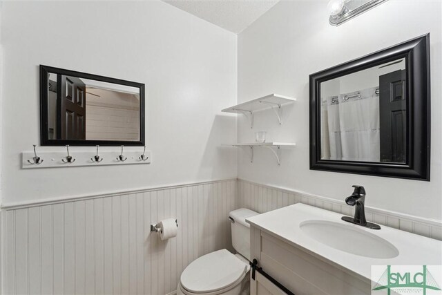 605 Weisenbaker Rd, Rincon, GA 31326 - bathroom with toilet, a wainscoted wall, and vanity