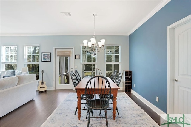 dining room featuring visible vents, baseboards, a notable chandelier, ornamental molding, and dark wood-style floors