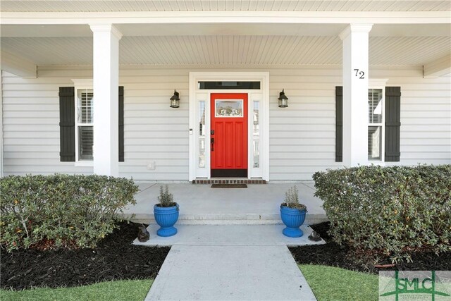 view of exterior entry with covered porch