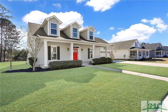cape cod house with concrete driveway, a front yard, an attached garage, and covered porch
