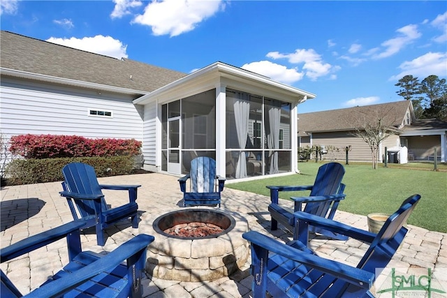view of patio / terrace featuring an outdoor fire pit and a sunroom