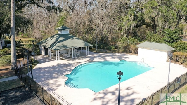 view of swimming pool featuring a patio area, a gazebo, fence, and a fenced in pool